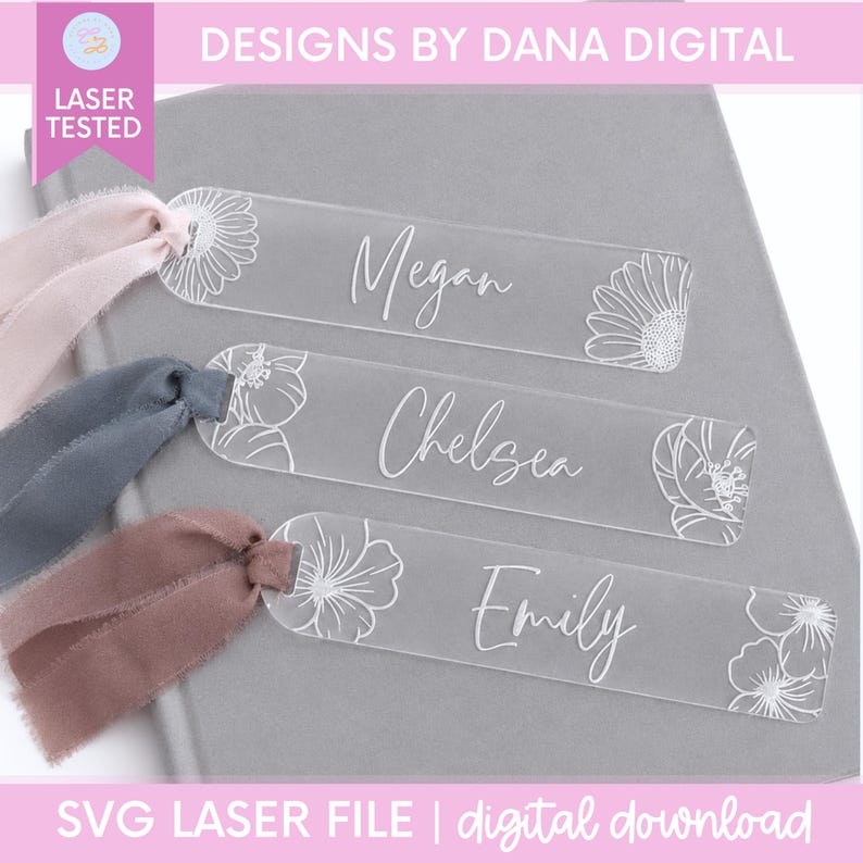 May include: Three rectangular clear acrylic bookmarks with rounded ends, each engraved with a floral design and a name: Megan, Chelsea, and Emily. Each bookmark features a frayed fabric ribbon tied through a hole at one end in light pink, blue, and mauve.