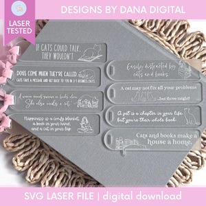 May include: Clear acrylic bookmarks with cat-themed quotes and illustrations. The bookmarks feature phrases like "If cats could talk, they wouldn't" and "Cats and books make a house a home." The design includes the text "DESIGNS BY DANA DIGITAL" and "SVG LASER FILE | digital download."