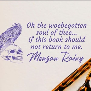 May include: A purple illustration of a raven perched on a skull with the text "Oh the woebegotten soul of thee... if this book should not return to me. Meagan Rainy" and a pair of tortoiseshell glasses on a white surface with the text "Glitter Puff" in black cursive.