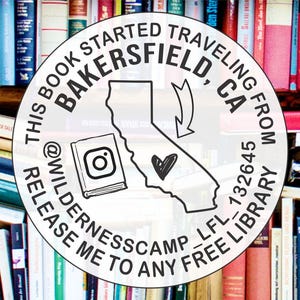 May include: A round white sticker with black text and a drawing of the state of California, a book, and a heart. The text reads: "This book started traveling from Bakersfield, CA 132645. Release me to any free library @Wildernesscamp_LFL."