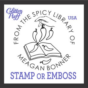 May include: A black and white graphic design featuring a hand holding chili peppers above an open book. Text includes "From The Spicy Library of Meagan Bonner" and "Stamp or Emboss". The logo also includes the text "Glitter Puff" and "USA".