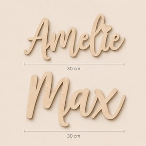 May include: Two wooden name signs, "Amelie" and "Max", in a cursive font. Each name is 30 cm long. The wood has a natural, light brown color. The names are displayed against a neutral background.