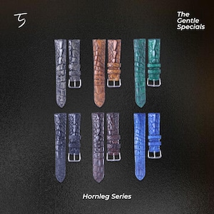 Könnte beinhalten: Eine Auswahl an Armbändern in verschiedenen Farben, darunter Schwarz, Braun, Grün, Blau und Lila. Die Armbänder haben ein strukturiertes, krokodilartiges Muster und silberne Schnallen. Der Text "Hornleg Series" ist unten zu sehen, und "The Gentle Specials" oben rechts.