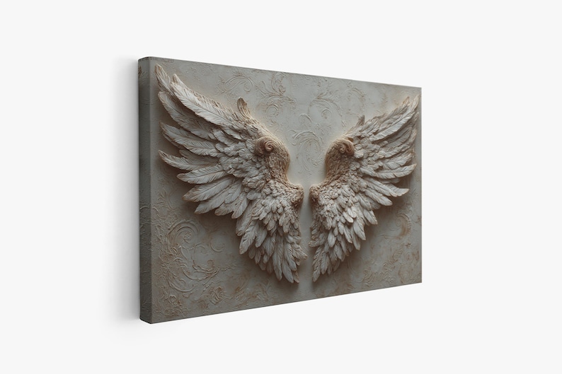 May include: A rectangular canvas print featuring a detailed relief of two symmetrical angel wings. The wings are rendered in a neutral color palette of beige and off-white, with intricate feather detailing. The background has a subtle, textured pattern.