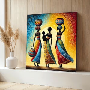 May include: A colorful square canvas art print depicting three silhouetted figures in long dresses, carrying pots on their heads. The artwork features a vibrant color palette of blue, yellow, and red, with a circular pattern background. One figure carries a child.