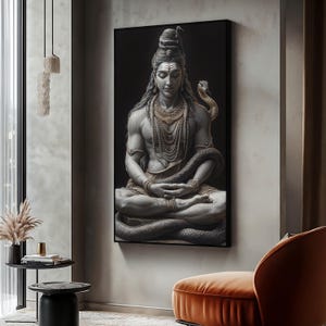May include: A black and white photo of a Hindu deity, Shiva, meditating in a seated position with a snake wrapped around his body. He is wearing a beaded necklace and has a third eye on his forehead.