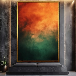 May include: Abstract painting with a gradient of orange, yellow, and green colors. The painting is framed in a gold frame and is hanging on a dark gray wall.