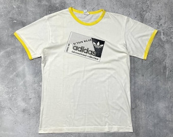 Camiseta blanca vintage de los 90 de la colección internacional Adidas Action Wear.