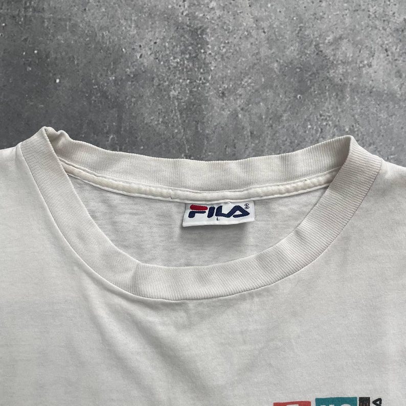 May include: A set of three ceramic mugs with a speckled, matte finish. The mugs are in shades of cream, light gray, and dark gray. Each mug has a simple, modern design and a rounded handle.