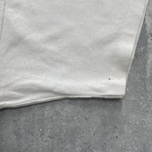 May include: A white ceramic mug with a black handle and the text "But First, Coffee" in a bold, black font. The mug is set against a neutral background, highlighting its simple design.