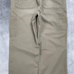 May include: A set of three ceramic mugs with a speckled, matte finish. The mugs are in shades of cream, light gray, and dark gray. Each mug has a simple, modern design and a rounded handle. The mugs are likely for coffee or tea.