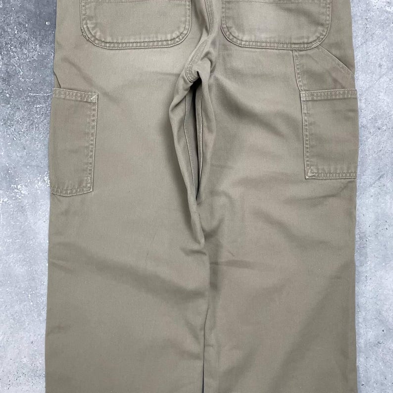 May include: A set of three ceramic mugs with a speckled, matte finish. The mugs are in shades of cream, light gray, and dark gray. Each mug has a simple, modern design and a rounded handle. The mugs are likely for coffee or tea.