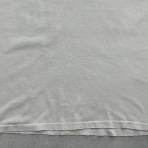 May include: A white ceramic mug with a black handle and the text "But First, Coffee" in a black, handwritten-style font. The mug is on a white surface.