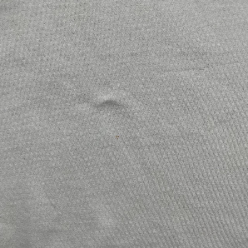 May include: A set of three ceramic mugs with a speckled, matte finish. The mugs are in shades of cream, light gray, and dark gray. Each mug has a simple, minimalist design and a rounded handle.