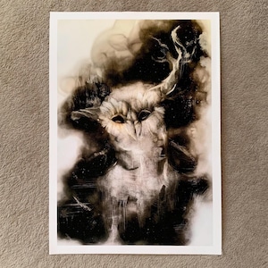 May include: A framed art print depicting an owl in a monochrome style. The image uses shades of black, white, and grey to create a textured effect. The owl's face is the focal point, with dark eyes and a detailed, textured appearance.