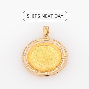 May include: Gold-coloured pendant with a circular design. The pendant has an inner circle with detailed patterns and an outer frame with a geometric design. The bail is a small loop at the top. The text "SHIPS NEXT DAY" is in a white rectangle.
