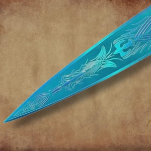 May include: Close-up of a teal-colored dagger blade with intricate, etched designs. The blade features a pointed tip and a series of stylized feather and geometric patterns. The background is a textured, tan surface.