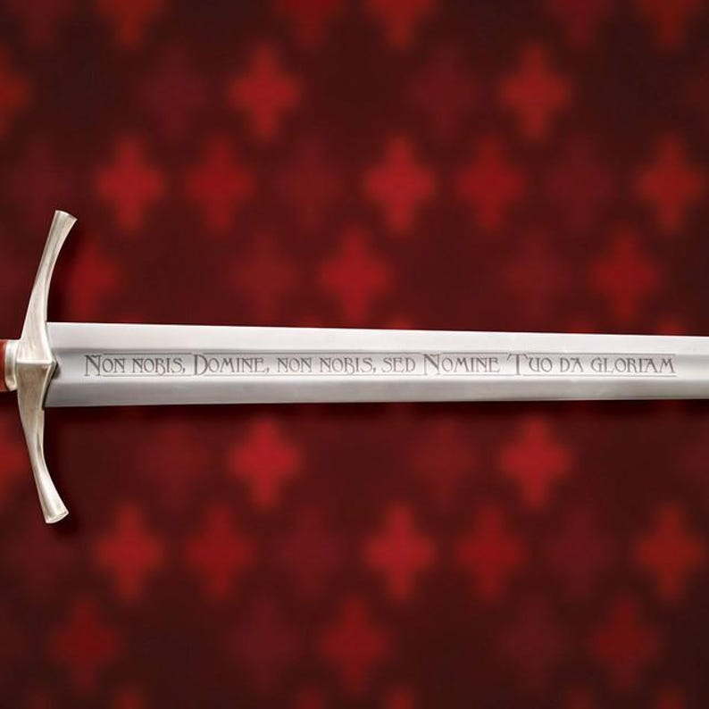 May include: A silver sword with a cross-shaped hilt and a long, engraved blade. The blade features the inscription "Non Nobis, Domine, Non Nobis, Sed Nomine Tuo Da Gloriam" in a serif font. The background is a dark red with a repeating pattern.