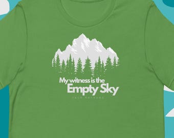 May include: Green t-shirt with a white graphic of a mountain range with trees and the text "My witness is the Empty Sky Jack Kerouac"