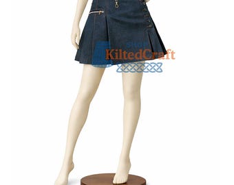 May include: A dark wash denim kilt skirt with a pleated design. The skirt features a zipper pocket, button details, and a decorative ring. The text "KiltedCraft" is visible on the skirt. The skirt is displayed on a mannequin.