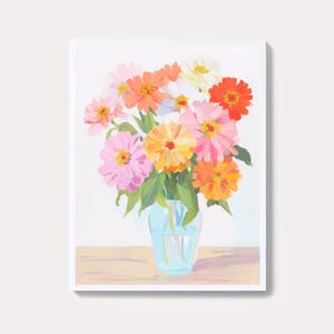 May include: A colorful floral painting featuring a bouquet of zinnias in a light blue glass vase. The flowers are in shades of pink, orange, yellow, and red, with green leaves. The artwork is set against a white background.