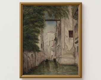 May include: A framed vintage painting depicts a canal scene in Venice, Italy. The artwork features a waterway with buildings on either side, a bridge, and a gondola. The painting is in a gold-colored frame.