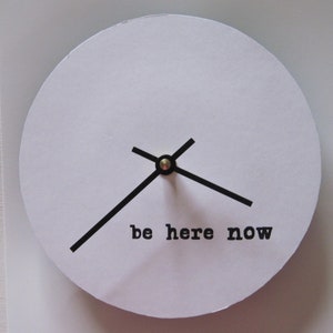 Clock with words.  Small bl and wh clock.  Be here now. Eco-friendly clock.  7 inch clock. Psychological therapy.