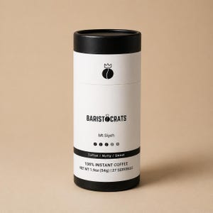 May include: A cylindrical coffee container with a black top and bottom, and a white central section. The label reads "BARISTOCRATS", "Mt Siyeh", and "100% INSTANT COFFEE NET WT 54g | 27 SERVINGS". The flavour profile is "Toffee / Nutty / Sweet".