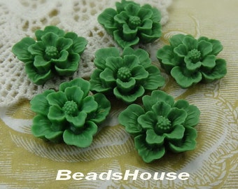 May include: Six green resin flower cabochons with a raised center. The flowers are approximately 1 inch in diameter.
