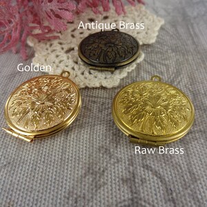May include: Three antique brass locket pendants with a floral design. The lockets are shown in three different finishes: antique brass, golden, and raw brass.