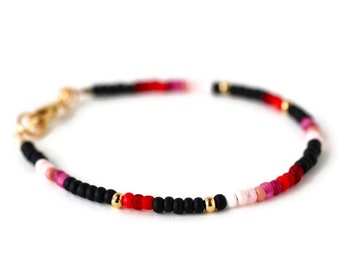 Dainty single strand beaded bracelet in black, pink, red, gold