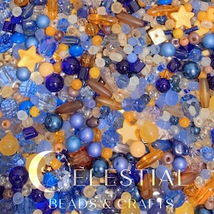 May include: A close-up of a mix of beads in various shapes and sizes. The beads are in shades of blue, yellow, and brown. Some beads are star-shaped. The text "CELESTIAL BEADS & CRAFTS" is at the bottom.