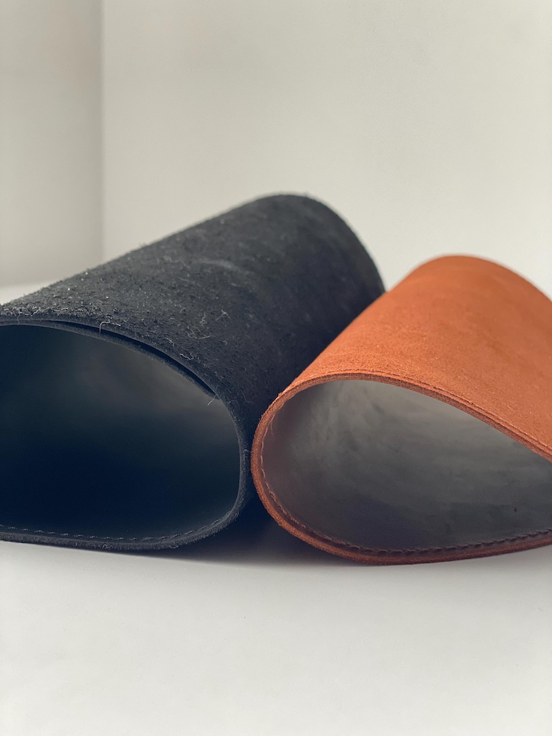 May include: A set of three ceramic mugs with a speckled, matte finish in cream, light grey, and dark grey. Each mug has a simple, minimalist design and a rounded handle.