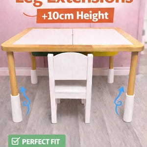 May include: An IKEA Flisat table with leg extensions, increasing the height by +10cm. The table features a white top, natural wood legs, and white extensions. A small white chair is positioned in front. The image includes the text "Perfect Fit" and "Multiple Colors".