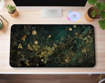 May include: A green and gold floral design mousepad with intricate swirls and butterflies. The mousepad has a dark green background with gold accents.