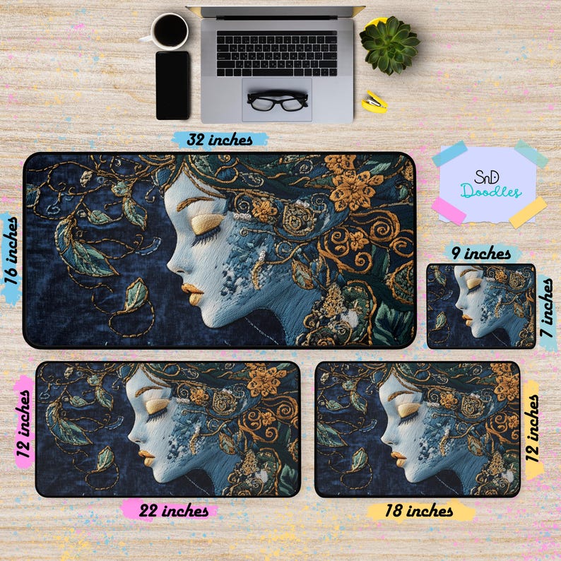 May include: A set of four mousepads featuring a blue and gold illustration of a woman's face with floral details. The largest mousepad is 32 inches by 16 inches, and the smaller mousepads are 22 inches by 12 inches, 18 inches by 12 inches, and 9 inches by 7 inches.