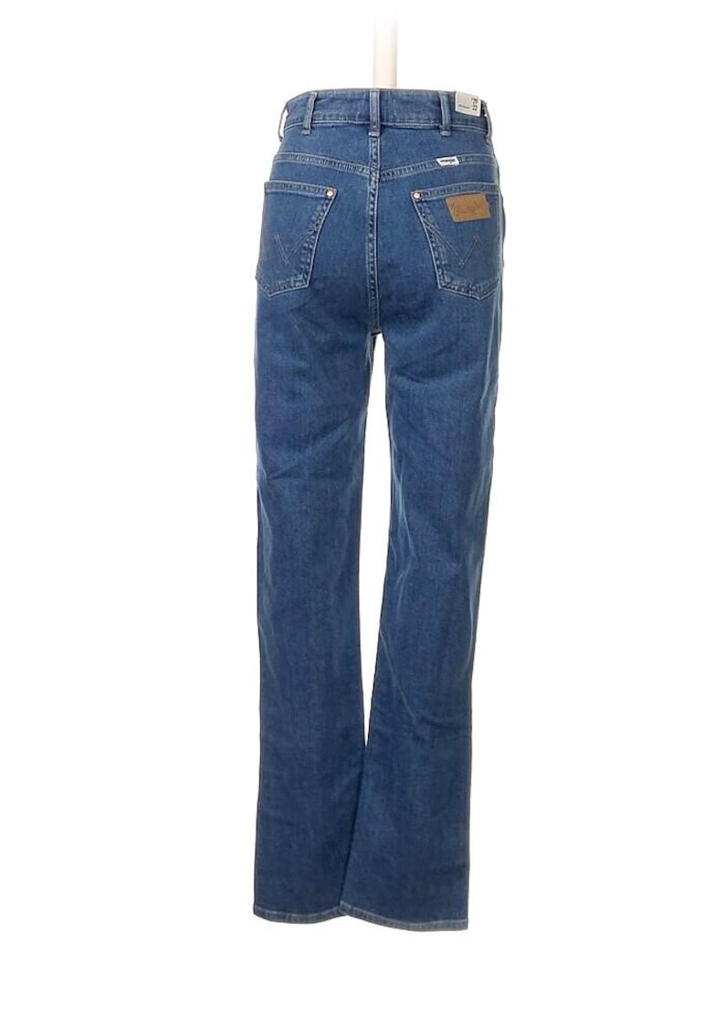 May include: Blue denim jeans with a classic five-pocket design. The jeans have a straight leg cut and a leather patch on the back pocket. The Wrangler logo is visible on the patch. The jeans are displayed against a white background.
