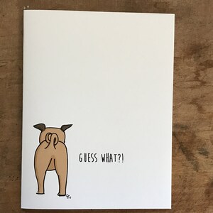 May include: A cartoon illustration of a dog's rear end with the text "GUESS WHAT?!" below it.