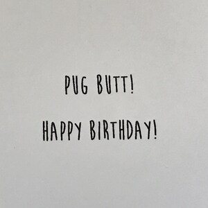 May include: A white card with black text that says "Pug Butt! Happy Birthday!"