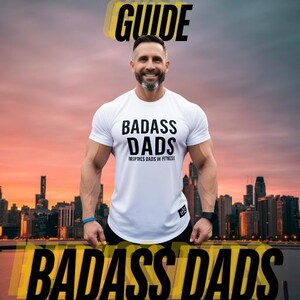 May include: A man in a white t-shirt with the text "BADASS DADS" stands in front of a city skyline at sunset. The shirt also has the text "INSPIRES DADS IN FITNESS". The words "START NOW GUIDE" and "BADASS DADS FITNESS" are overlaid in yellow.