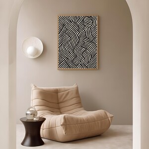 Black and white abstract line art poster featuring bold geometric striped patterns woven into a modern minimalist design on a beige background.