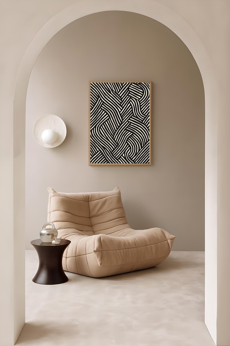 Black and white abstract line art poster featuring bold geometric striped patterns woven into a modern minimalist design on a beige background.