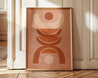 May include: Framed abstract art print featuring a geometric design in shades of peach, cream, and terracotta. The artwork includes semi-circles and circles arranged in a vertical composition. The gold frame complements the warm color palette.