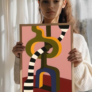 Contemporary abstract artwork featuring bold interlocking geometric shapes in olive green, gold, navy, and black-and-white stripes on a pink and red background.