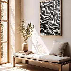 Black and white abstract line art poster featuring bold geometric striped patterns woven into a modern minimalist design on a beige background.