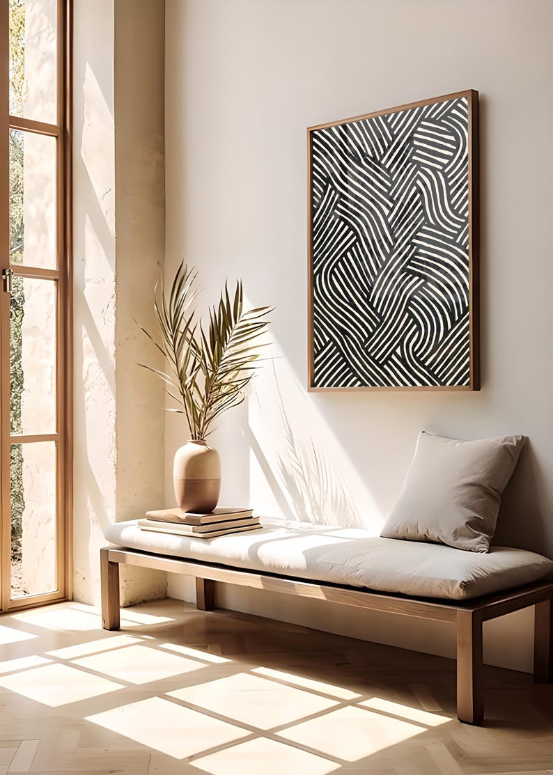Black and white abstract line art poster featuring bold geometric striped patterns woven into a modern minimalist design on a beige background.
