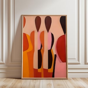 Puede incluir: Impresión artística abstracta con una composición de figuras estilizadas en tonos naranja, rojo, rosa y marrón. La obra de arte está enmarcada en un marco de madera fino y de color claro y cuelga contra una pared blanca y un suelo de madera.