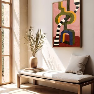 Contemporary abstract artwork featuring bold interlocking geometric shapes in olive green, gold, navy, and black-and-white stripes on a pink and red background.