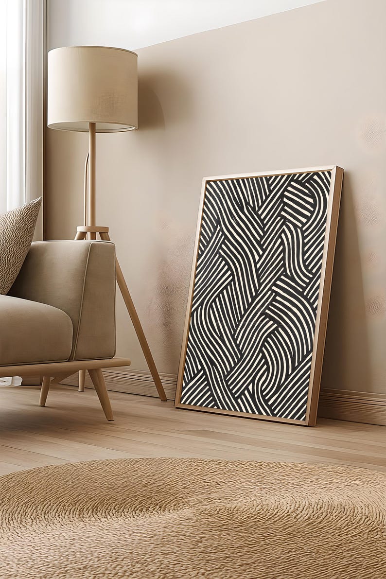 Black and white abstract line art poster featuring bold geometric striped patterns woven into a modern minimalist design on a beige background.