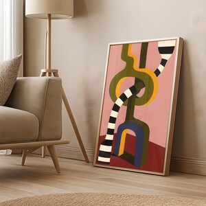 Contemporary abstract artwork featuring bold interlocking geometric shapes in olive green, gold, navy, and black-and-white stripes on a pink and red background.